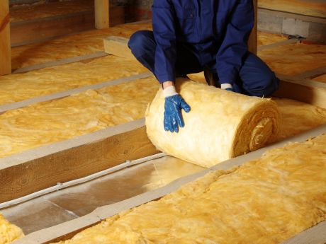 Loft insulation being laid in roof space