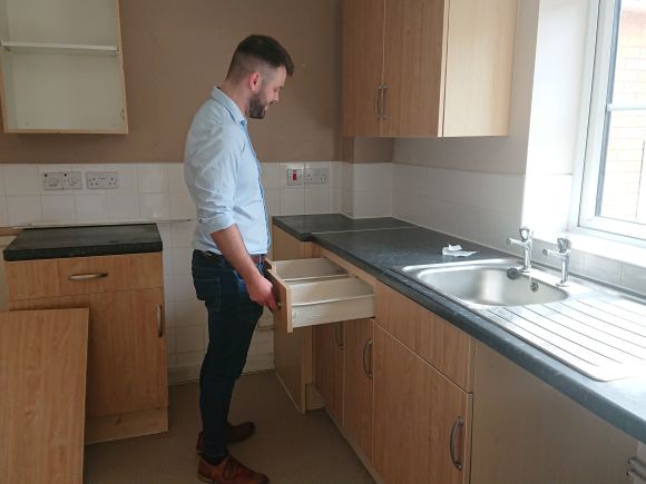 Stock condition survey Jack Tighe inspecting a kitchen