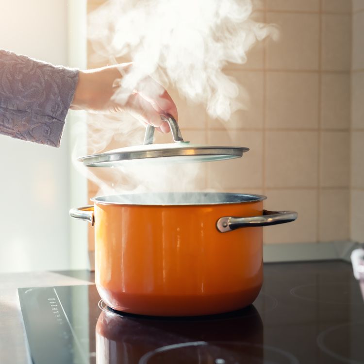 Pan on cooker with steam coming out