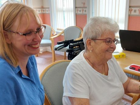 Female Platform colleague helping a customer get online 